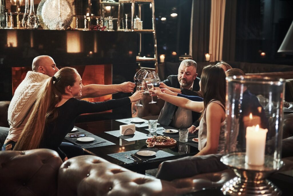 Family friends having nice time in beautiful luxury modern restaurant